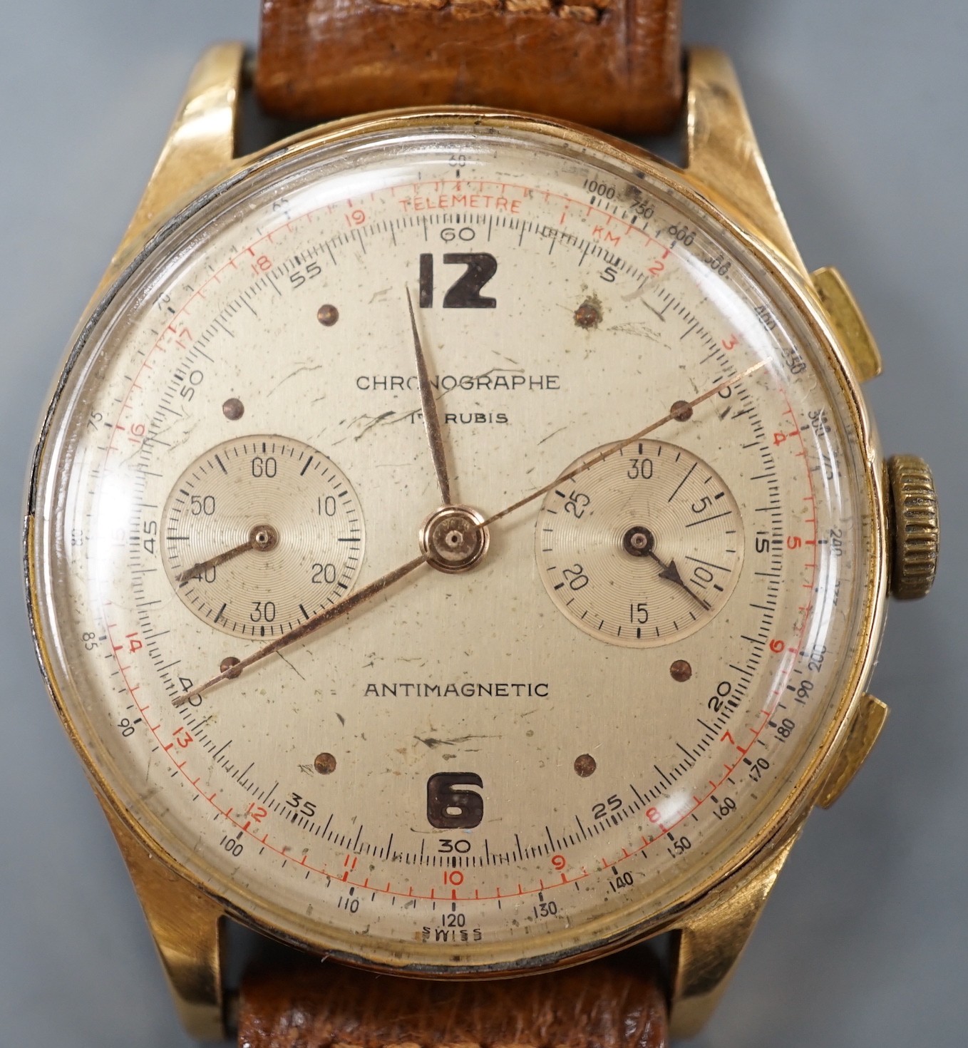 A 1940/1950's? Swiss 18k chronograph wrist watch, with two subsidiary dials, on a brown leather strap, case diameter 37mm, gross weight 45.5 grams.